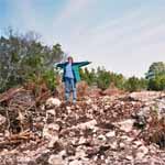 Jane is standing on a pile of rocks known as the septic tank at Babble On Industries.